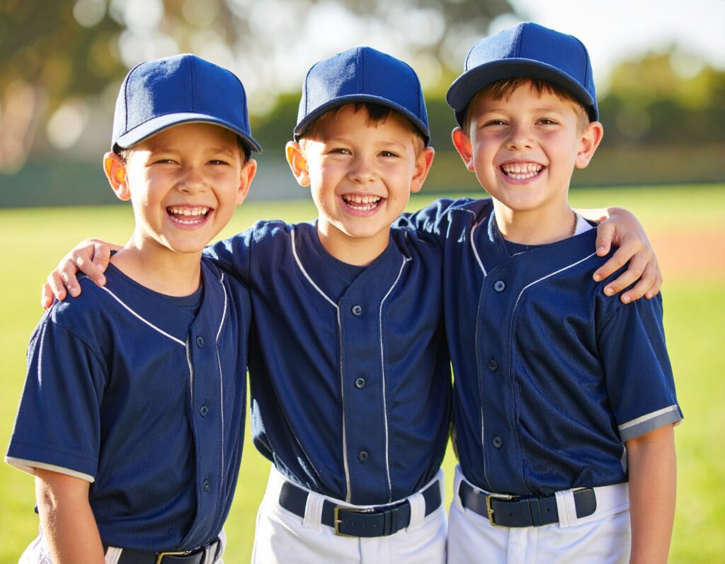 Three best fiends in full uniform posing for a photo after a baseball game.