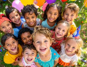 Group of kids playing and posing together at a backyard birthday party. 