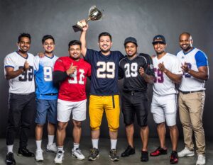 Group of men who play fantasy football celebrating with the league champion.