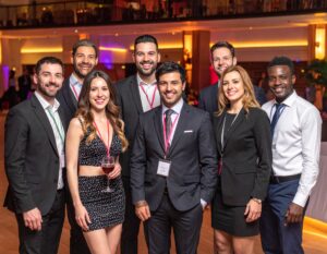 Group of 8 co workers at a convention in formal business attire. 